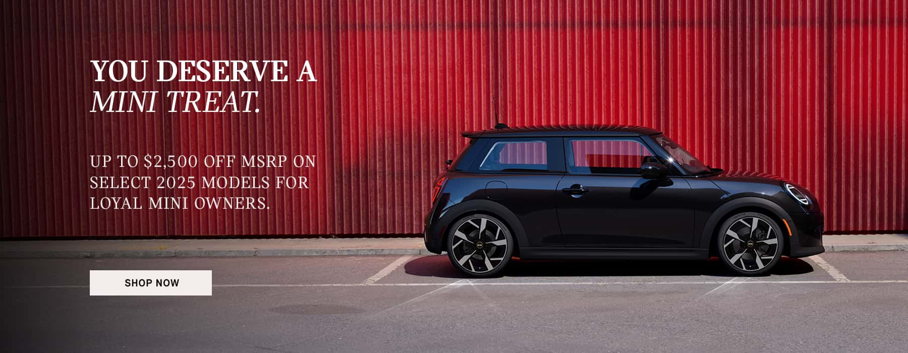 Black MINI Cooper parked in front of a building.