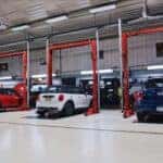 Three vehicles being serviced at a MINI service center