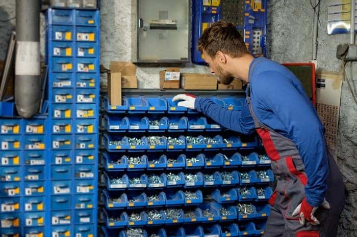 Mechanic selecting the right MINI Cooper parts for a vehicle