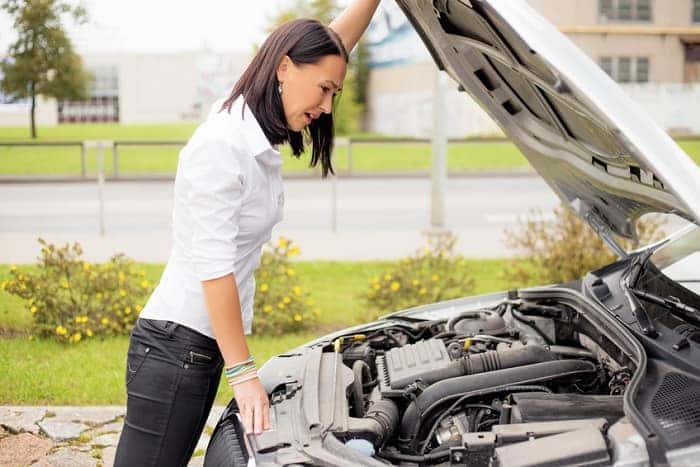Woman near broken-down car