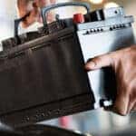MINI service technician installing a new battery