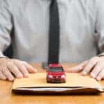 MINI financing paperwork with toy car on top