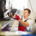 MINI technician performing wheel alignment service