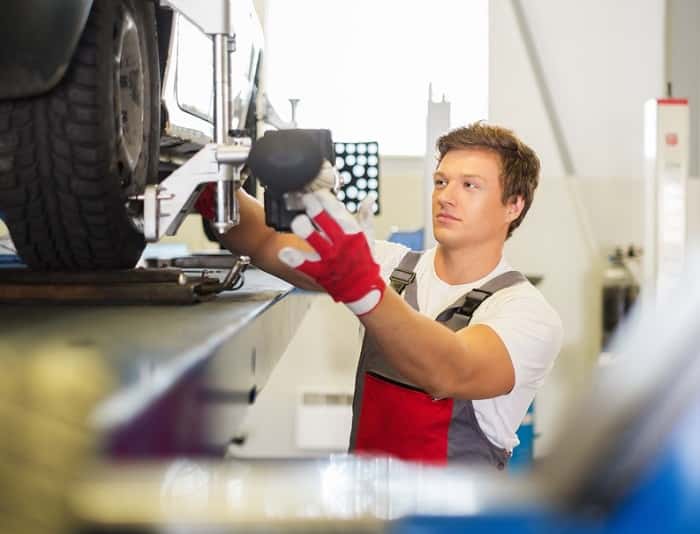 MINI technician performing wheel alignment service