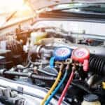 MINI service technician inspecting AC components