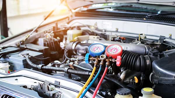 MINI service technician inspecting AC components
