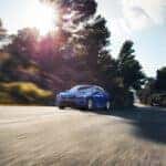 2023 Honda Civic Sedan LX driving down a road