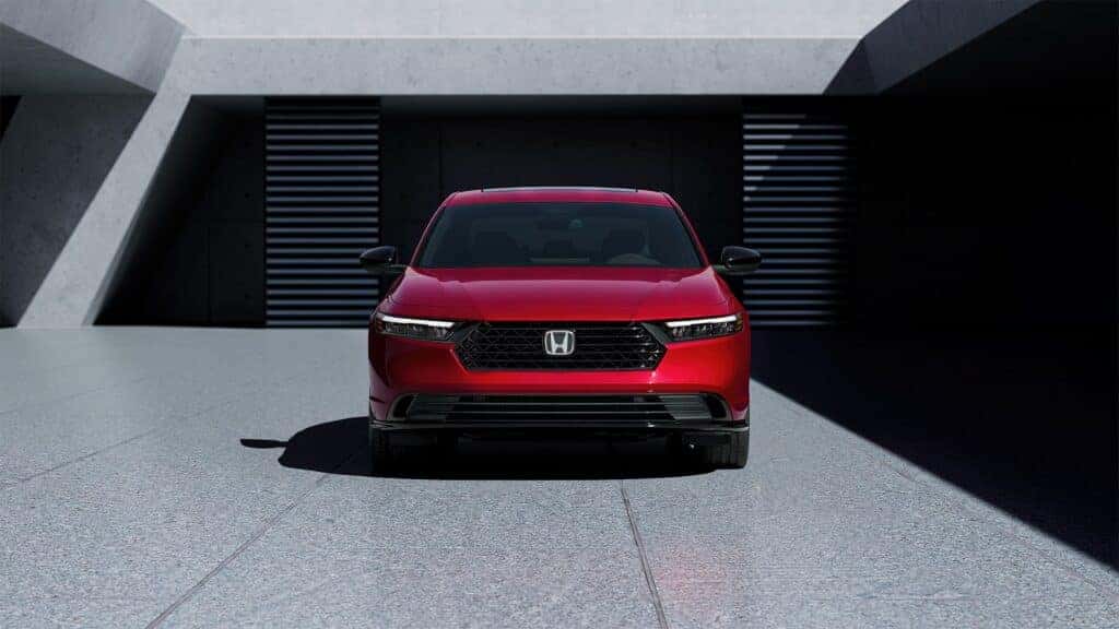 The front of a red 2023 Honda Accord Hybrid