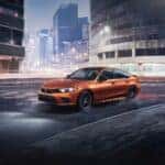 The 2023 Honda Civic Si driving in a cityscape