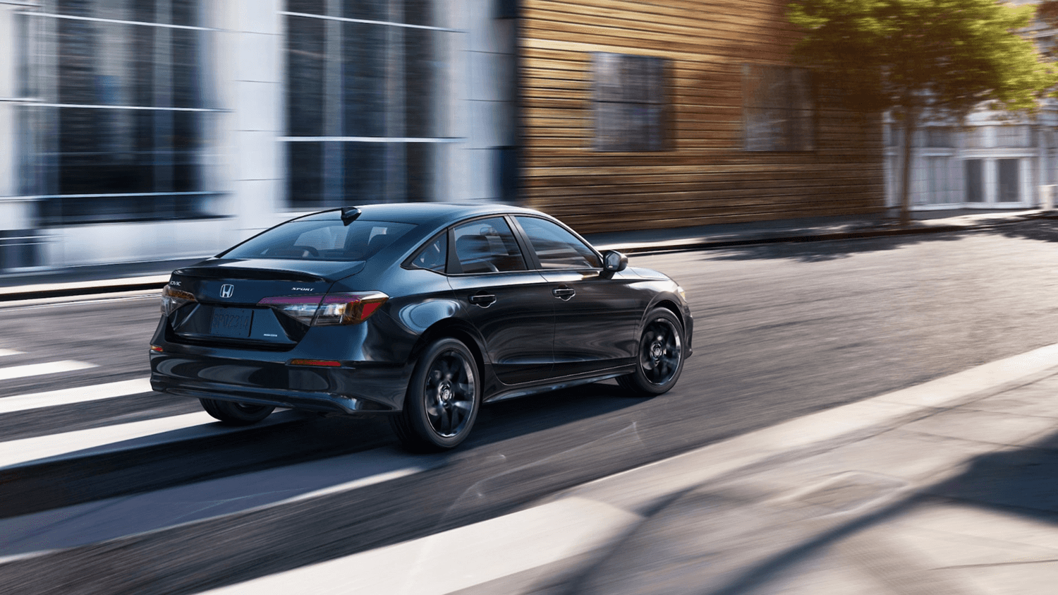 2025 Honda Civic driving down the road