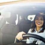 Smiling woman driving a car