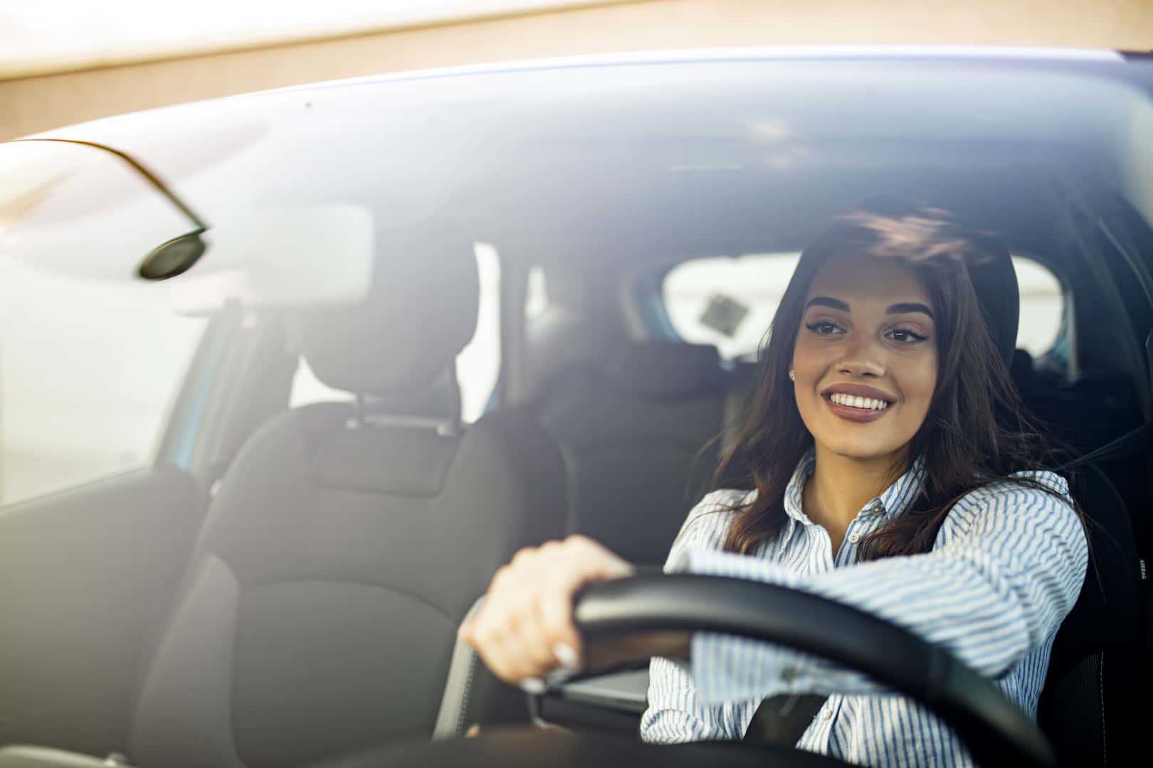 Smiling woman driving a car