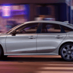 2025 Honda Civic side view driving at night