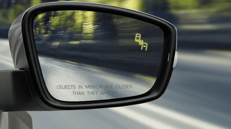 Blind spot monitoring light on mirror close up