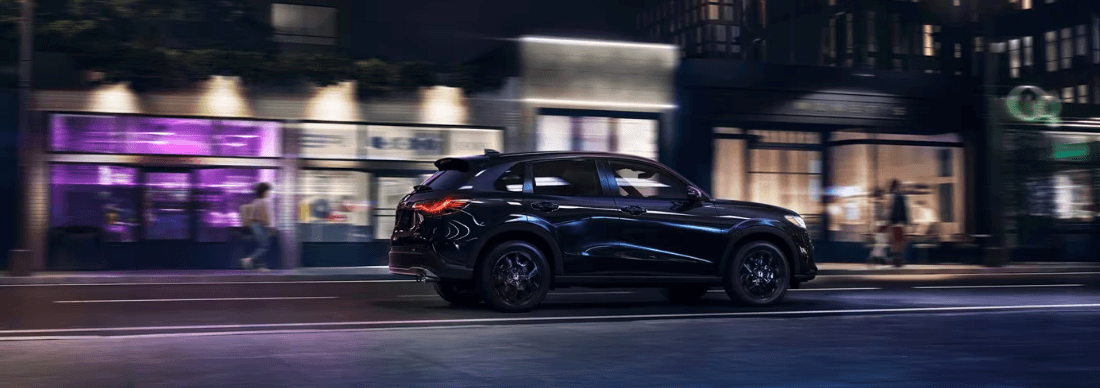 2026 Honda HR-V driving down a city street at night