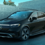 A black Mercedes-Benz AMG EQE SUV parked in a driveway.