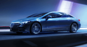 A silver Mercedes-Benz EQS 450 4MATIC AWD driving through a light tunnel.