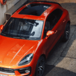 Porsche Macan EV in a side street.