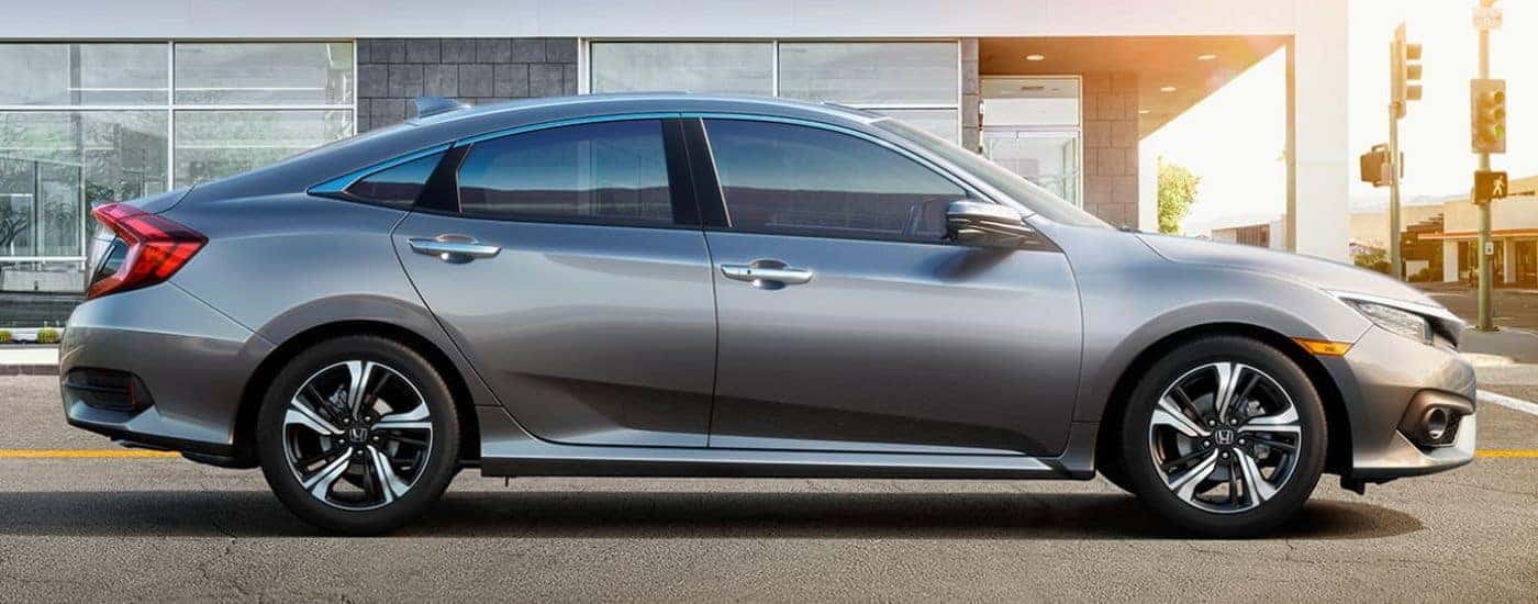 A silver 2016 Honda Civic is shown from the side.