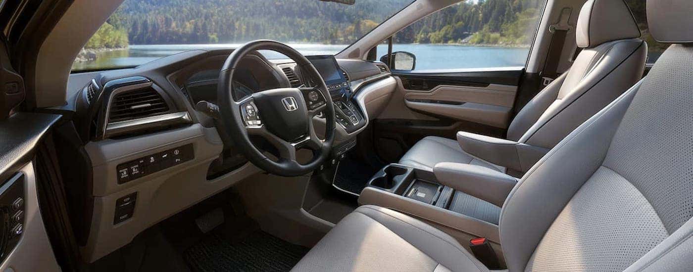 A white 2024 Honda Odyssey Elite is shown from the drivers side.
