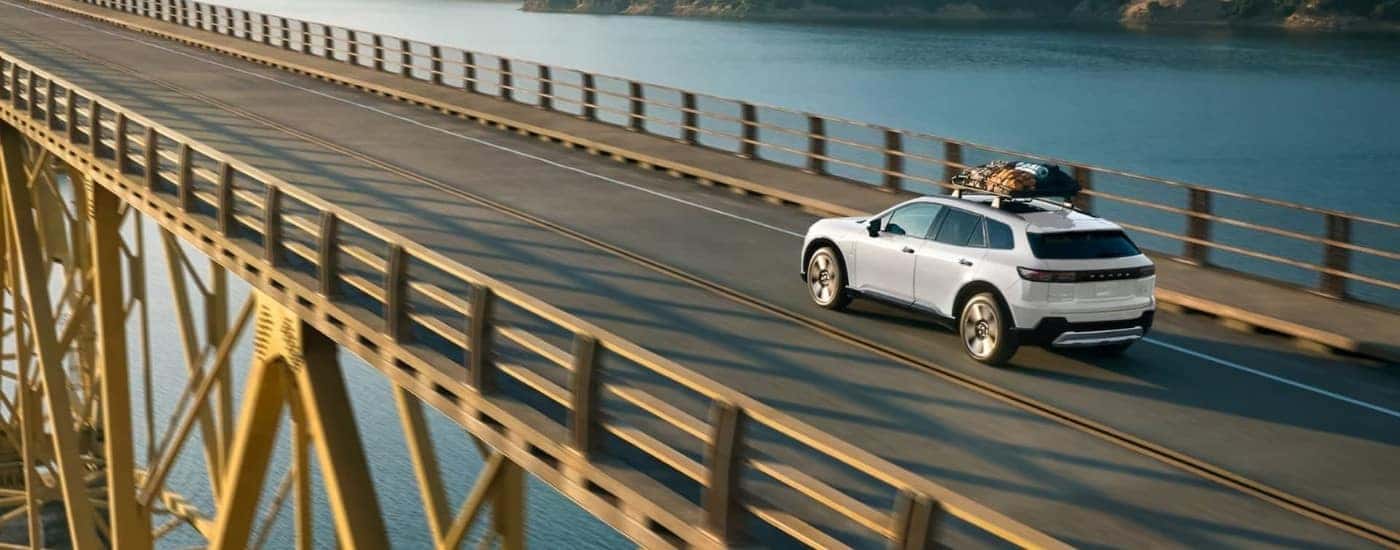 A white 2024 Honda Prologue Elite is shown driving on a bridge.