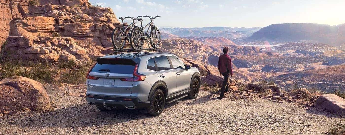Rear angle view of a grey 2023 Honda CR-V Sport Touring Hybrid.