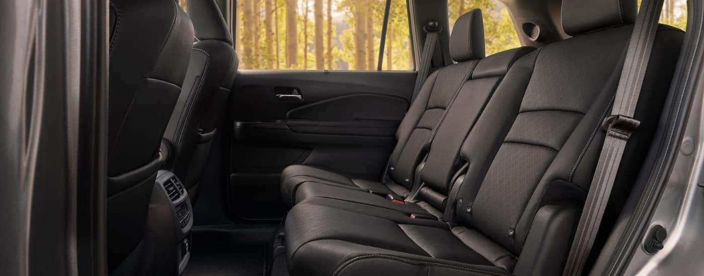 A close-up shows the rear leather seats in a silver 2021 Honda Passport for sale.