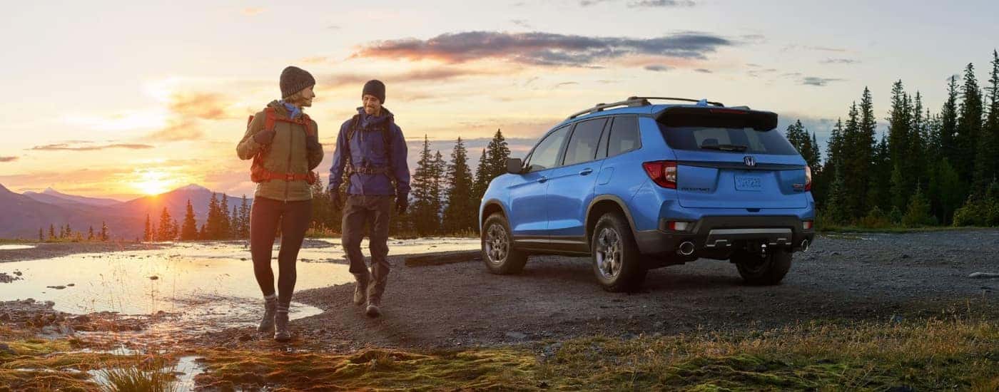A blue 2025 Honda Passport TrailSport is shown at sunrise.