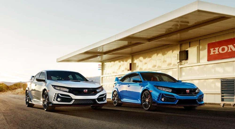 A white and a blue 2020 Honda Civic Type R are shown from the front.