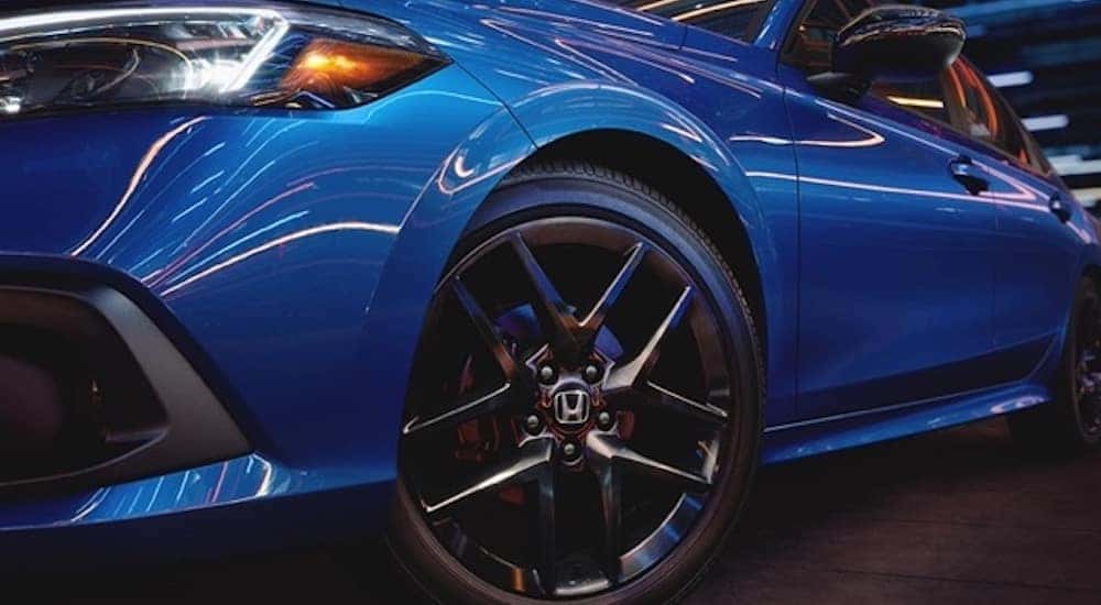 A blue 2022 Honda Civic is shown in close-up after the owner searched how to "sell my car".