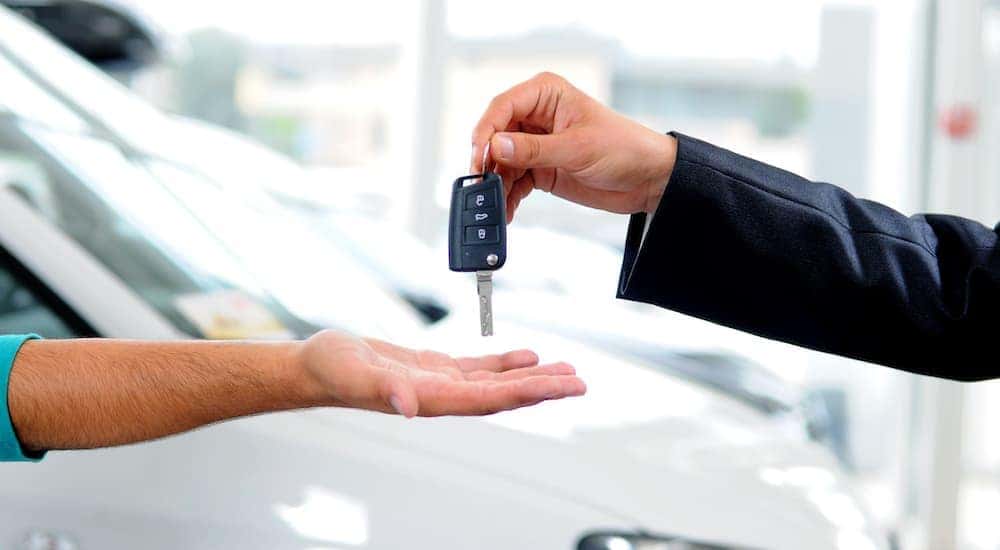 Keys are shown exchanging hands.