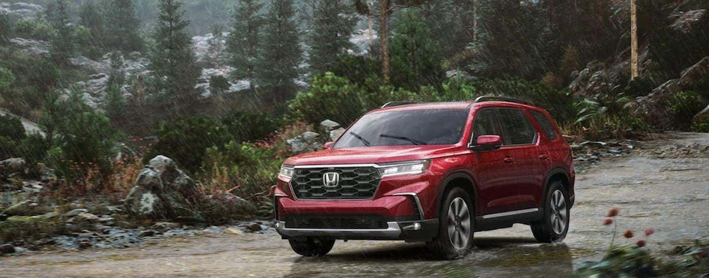 A red 2025 Honda Pilot from the front.