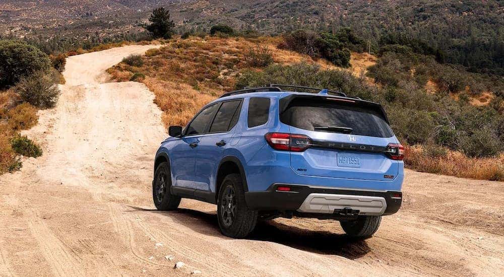 A blue 2025 Honda Pilot for sale from the rear.