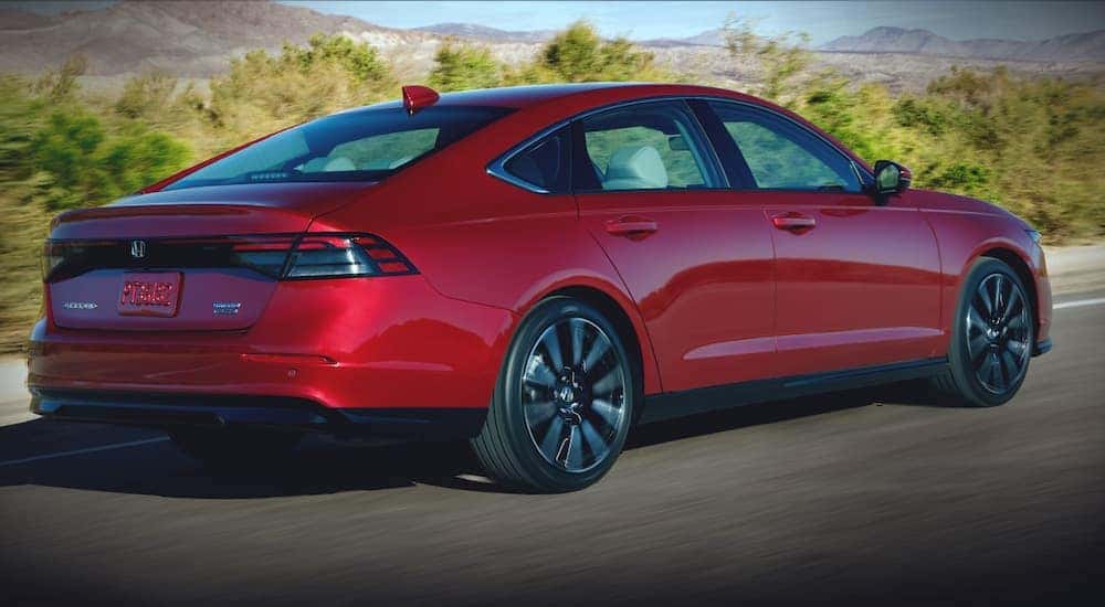 A red 2025 Honda Accord from the side.