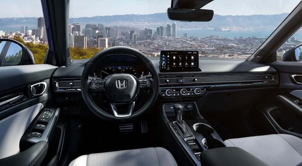 Steering wheel, infotainment and digital gauge cluster in a 2026 Honda Civic.
