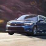 Blue 2025 Honda Civic Hybrid LX for sale in Knoxville driving on an open road