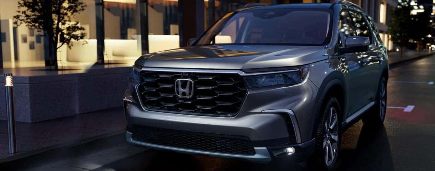 Grey 2023 Honda Pilot parked outside of a restaurant
