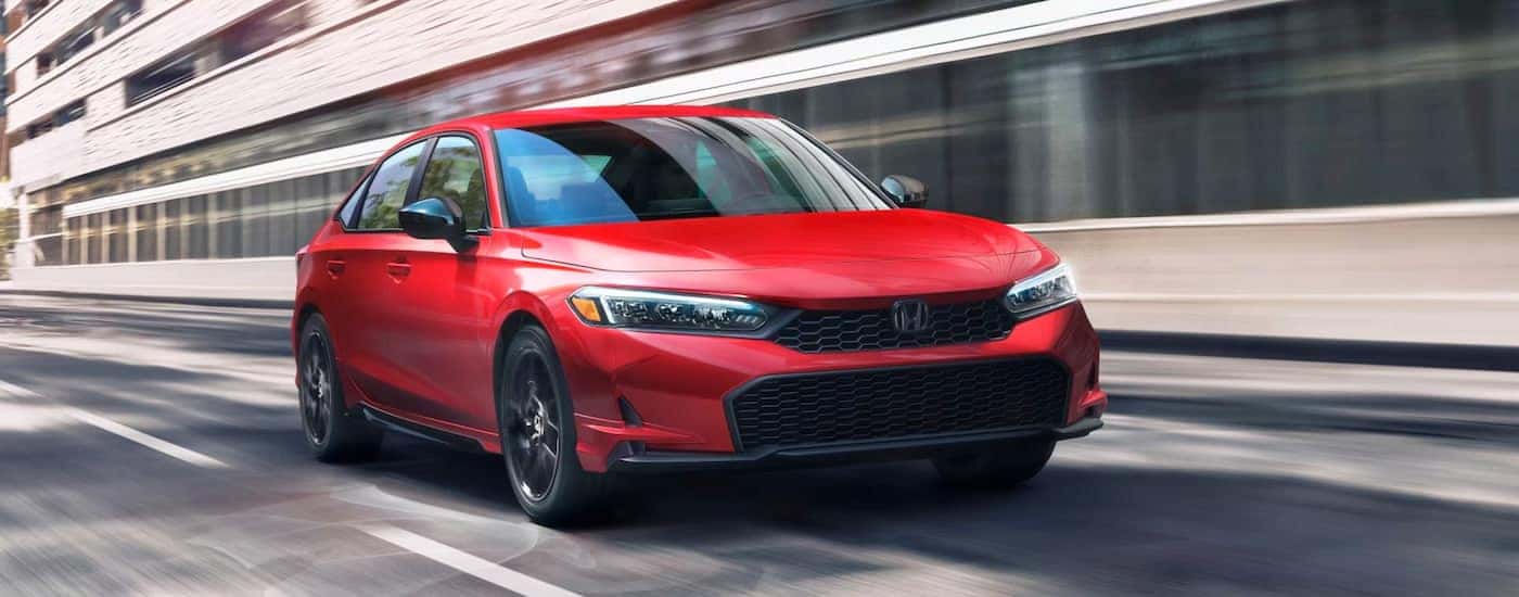 Red 2025 Honda Civic Sport driving on a highway
