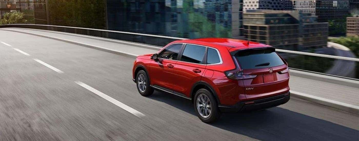 A red 2025 Honda CR-V from the rear at an angle.