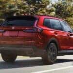 A red 2026 Honda CR-v driving on a highway.