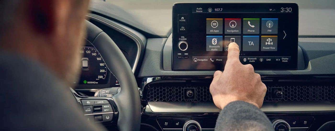 A person uses the infotainment system in their 2025 Honda CR-V
