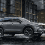 Silver 2026 Honda CR-V Hybrid for sale near Alcoa on a test drive through a city