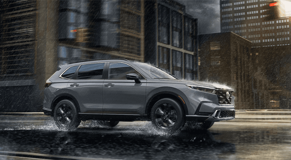 Silver 2026 Honda CR-V Hybrid for sale near Alcoa on a test drive through a city