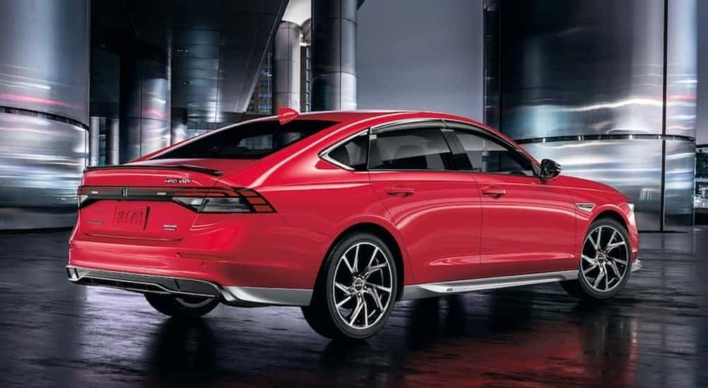 A red 2026 Honda Accord Touring Hybrid parked near pillars.