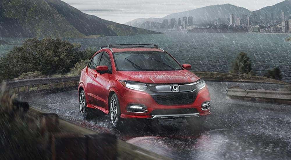 Red 2020 Honda HR-V driving through the rain