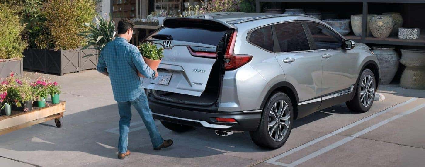 Silver 2021 Honda CR-V Touring with person using rear power liftgate.