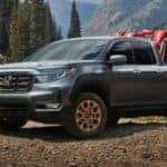 Grey 2021 Honda Ridgeline with dirt bikes in the bed
