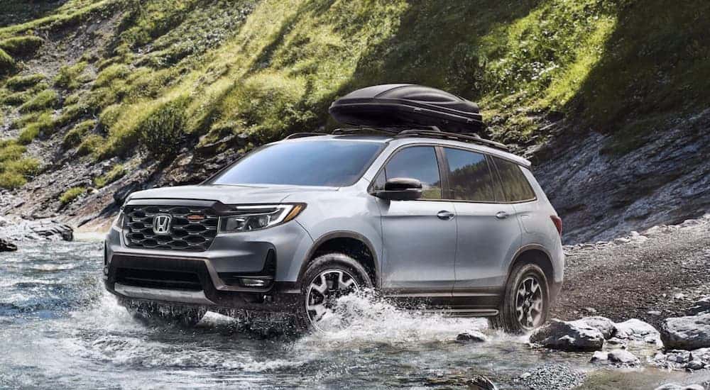 Silver 2022 Honda Passport TrailSport driving into a river
