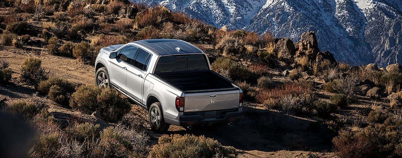 Silver 2022 Honda Ridgeline RTL-E driving up a mountain