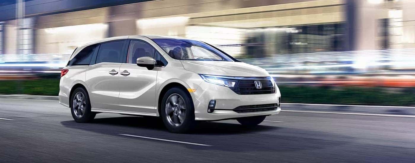 White 2023 Honda Odyssey with a blurred background.